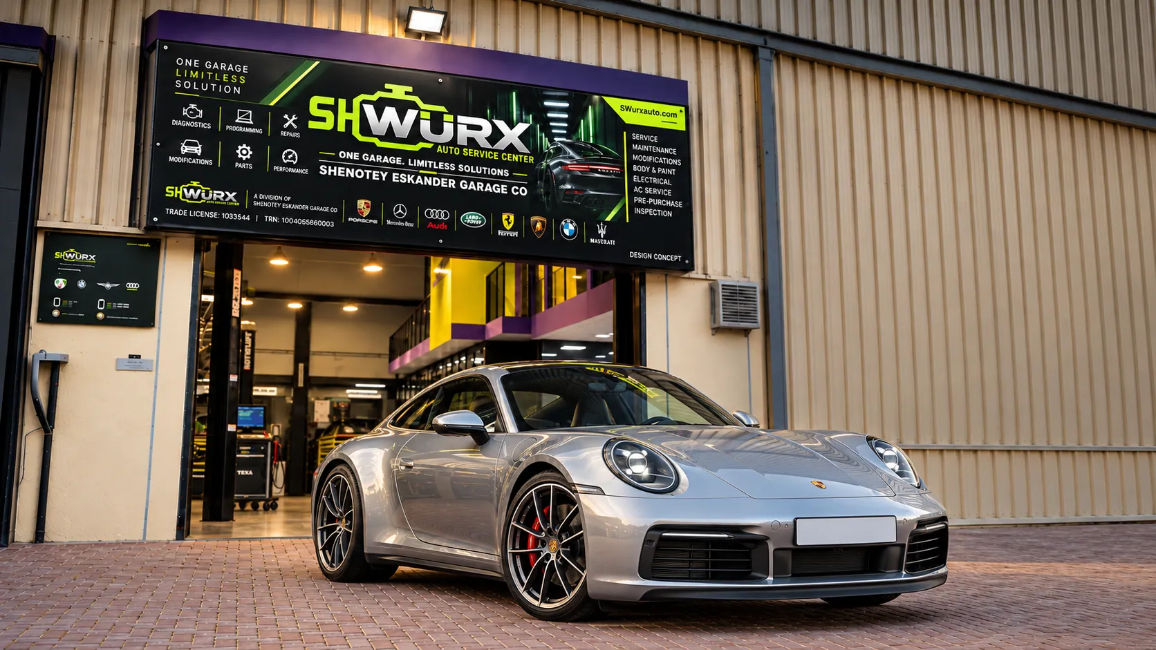Porsche outside the SHWURX-branded workshop facade